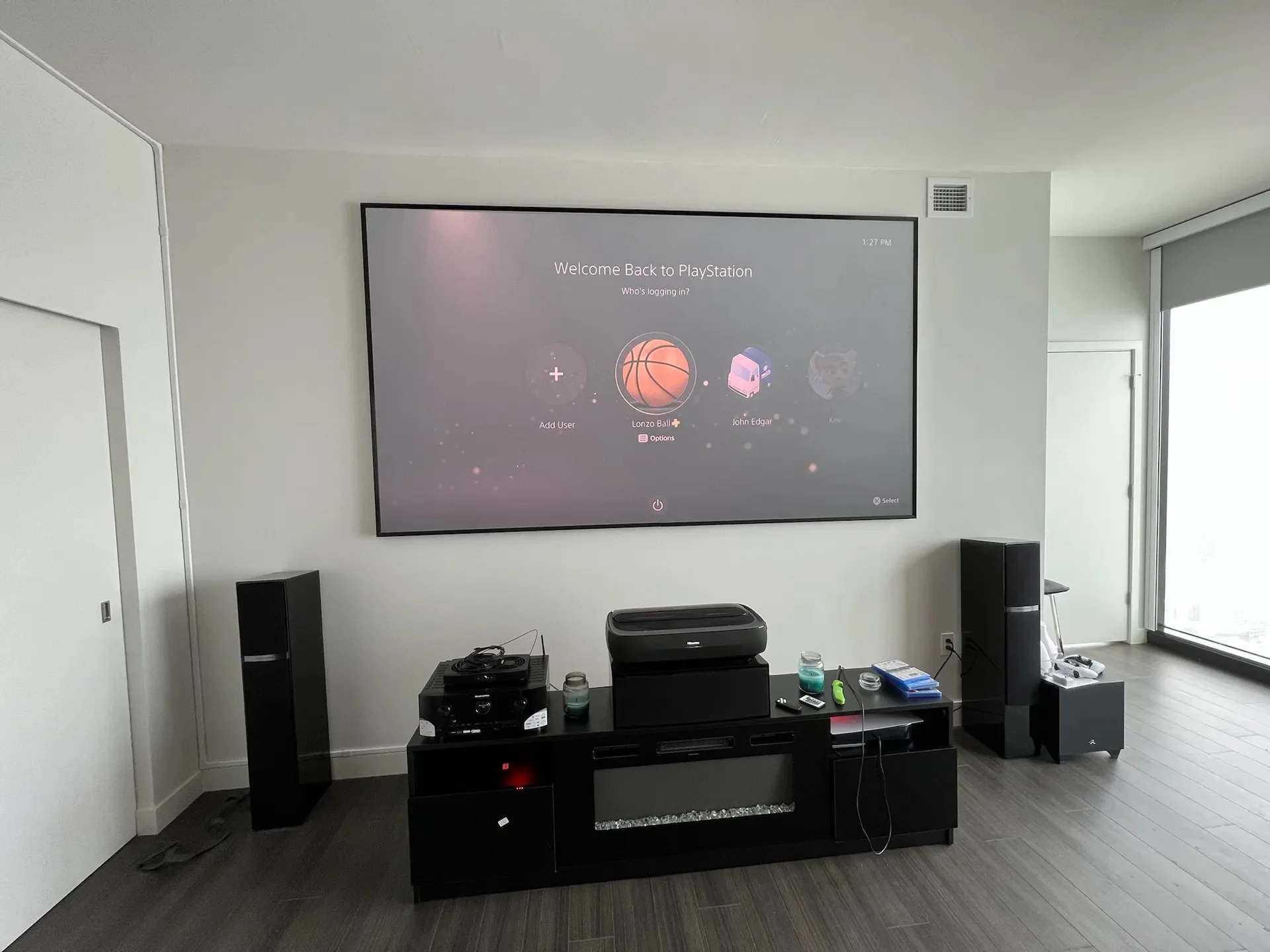 Home theater setup with in-ceiling speakers above fireplace in Chicago home