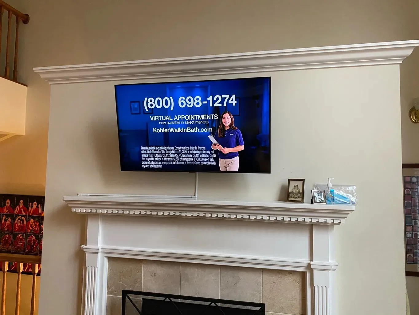 TV mounted above fireplace mantel