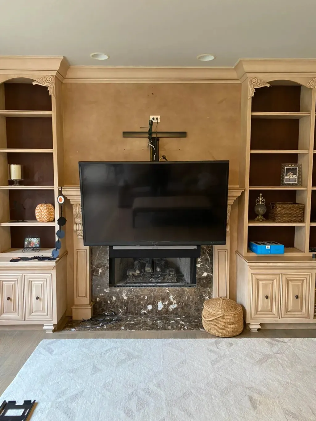TV mounted on stone mantle